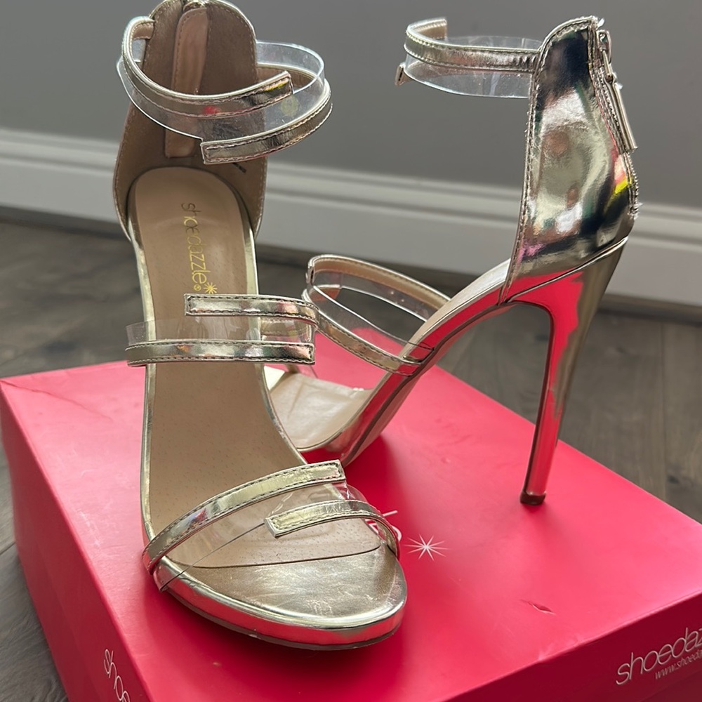 Woman’s Gold and Clear Heels